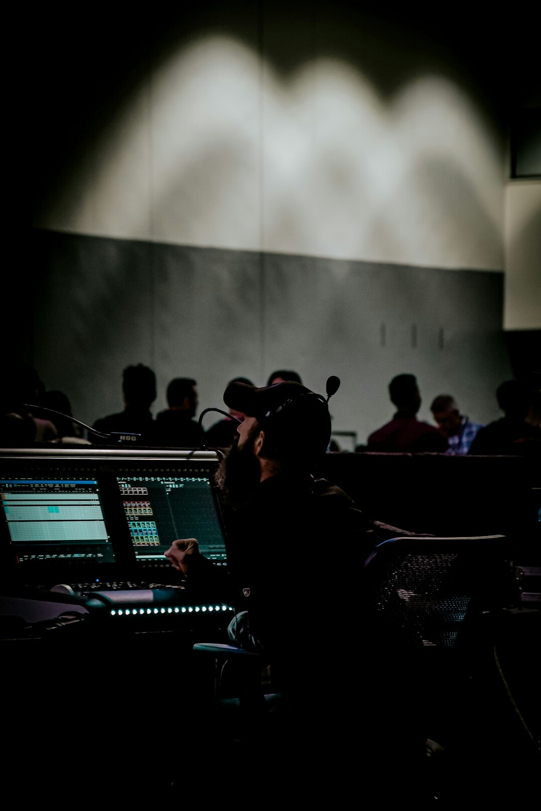 Broadcast control room with multiple video monitors and operators