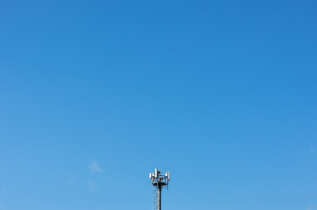 Satellite uplink dish against a clear sky
